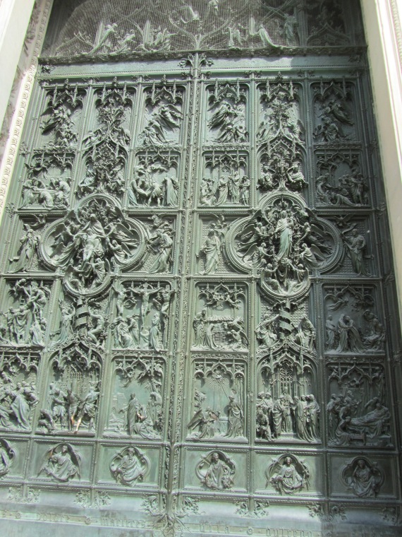 One of the 5 doors along the front of Milano Duomo, Italy
